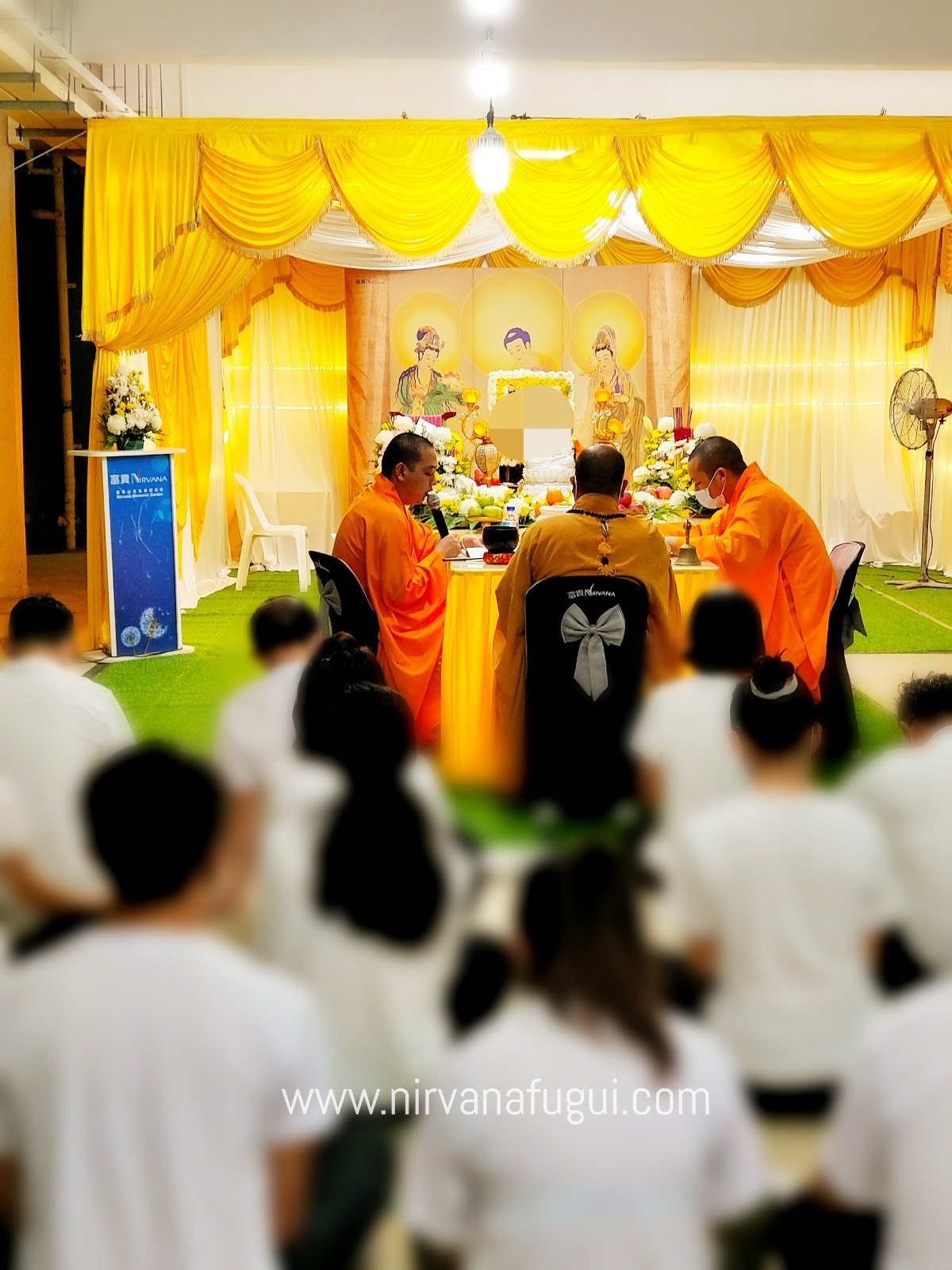 Buddhist monks reciting sutra at a Buddhist funeral rite organised by Nirvana Singapore