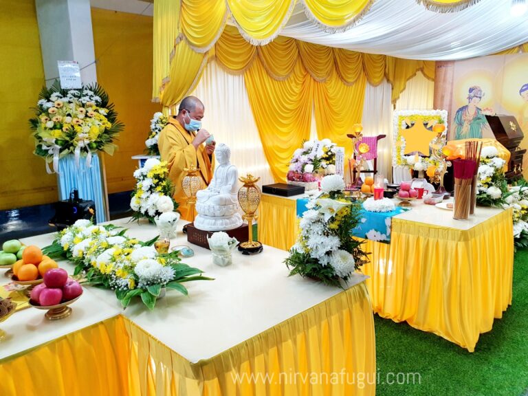 Senior Buddhist priest preparing for the ritual at a HDB void deck Buddhist funeral organised by Nirvana Singapore