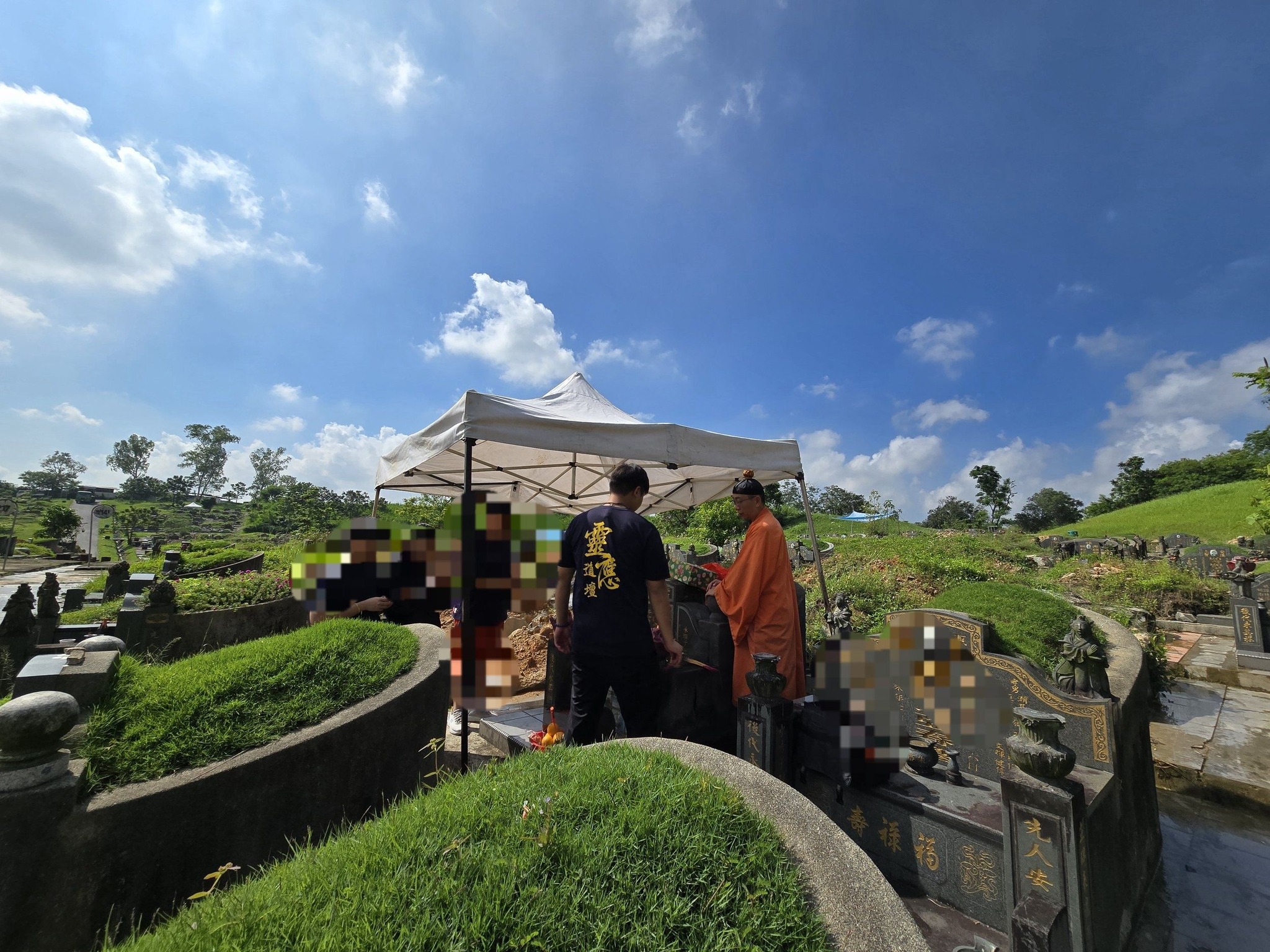 Exhumation ceremony in Singapore with Taoist master and family at graveside